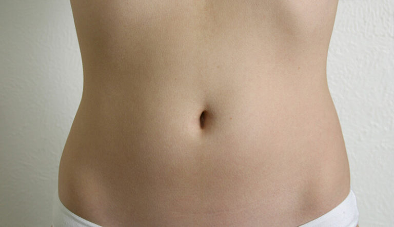 Photo of smooth, flat woman's belly